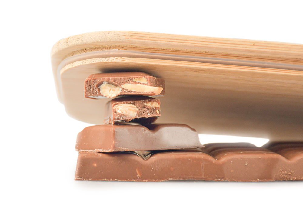 Close-up view of bamboo lid on brown tiles with screws and hinges – replacement lid for lunch box