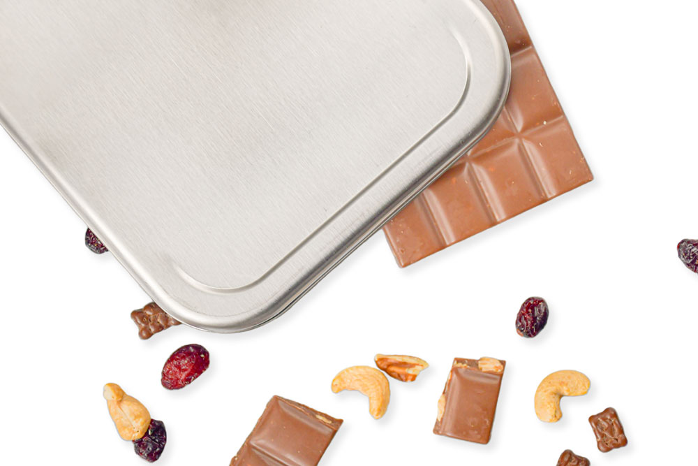 Close-up view of stainless steel lid with chocolate, nuts, and dried fruit – sustainable replacement lid for lunch box