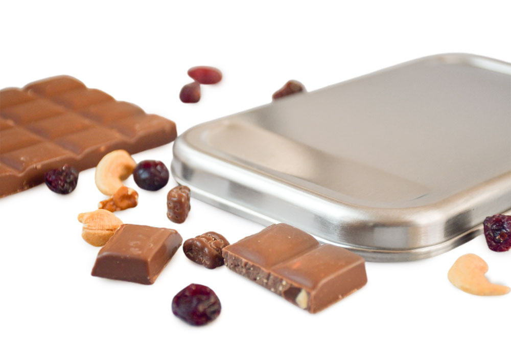 Close-up stainless steel lid for lunch box with chocolate, nuts, and dried fruit – high-quality replacement lid made of stainless steel